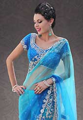 Take the fashion industry by storm in this beautiful embroidered saree. This shaded blue net saree is nicely designed with embroidered patch work is done with stone work. Beautiful embroidery work on saree make attractive to impress all. This saree gives you a modern and different look in fabulous style. Matching blouse is available. Slight color variations are possible due to differing screen and photograph resolution.
