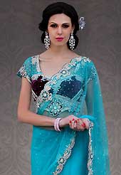 Exquisite combination of color, fabric can be seen here. This blue net lehenga style saree is nicely designed with embroidery and velvet patch work is done with resham, stone and cutbeads work. Beautiful embroidery work on saree make attractive to impress all. This saree gives you a modern and different look in fabulous style. Matching net and velvet blouse is available. Slight color variations are possible due to differing screen and photograph resolution.