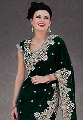 Different colors are a perfect blend of traditional Indian heritage and contemporary artwork. This dark green velvet and net saree is nicely designed with embroidery patch work is done with stone, zardosi and cutbeads work. Beautiful embroidery work on saree make attractive to impress all. This saree gives you a modern and different look in fabulous style. Matching blouse is available. Slight color variations are possible due to differing screen and photograph resolution.