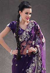 Era with extension in fashion, style, Grace and elegance have developed grand love affair with this ethnical wear. This purple net saree is nicely designed with embroidery patch work is done with resham, sequins, stone, zardosi and cutbeads work. Beautiful embroidery work on saree make attractive to impress all. This saree gives you a modern and different look in fabulous style. Matching blouse is available. Slight color variations are possible due to differing screen and photograph resolution.