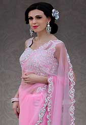 Embroidered sarees are the best choice for a girl to enhance her feminine look. This light pink net saree is nicely designed with embroidery patch work is done with stone work. Beautiful embroidery work on saree make attractive to impress all. This saree gives you a modern and different look in fabulous style. Matching blouse is available. Slight color variations are possible due to differing screen and photograph resolution.