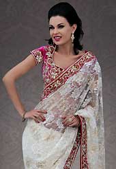 Take the fashion industry by storm in this beautiful embroidered saree. This off white net saree is nicely designed with embroidery patch work is done with stone work. Beautiful embroidery work on saree make attractive to impress all. This saree gives you a modern and different look in fabulous style. Contrasting magenta velvet blouse is available. Slight color variations are possible due to differing screen and photograph resolution.