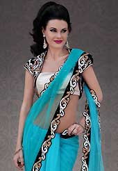 It is color this season and bright shaded suits are really something that is totally in vogue. This blue net saree is nicely designed with embroidery patch work is done with resham, stone and cutbeads work. Beautiful embroidery work on saree make attractive to impress all. This saree gives you a modern and different look in fabulous style. Contrasting off white and black blouse is available. Slight color variations are possible due to differing screen and photograph resolution.