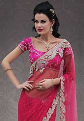 Keep the interest with this designer embroidery saree. This dark pink net saree is nicely designed with embroidery patch work is done with resham, stone and cutbeads work. Beautiful embroidery work on saree make attractive to impress all. This saree gives you a modern and different look in fabulous style. Matching blouse is available. Slight color variations are possible due to differing screen and photograph resolution.