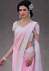 Attract all attentions with this embroidered saree. This light pink net saree is nicely designed with embroidery patch work is done with stone work. Beautiful embroidery work on saree make attractive to impress all. This saree gives you a modern and different look in fabulous style. Matching blouse is available. Slight color variations are possible due to differing screen and photograph resolution.