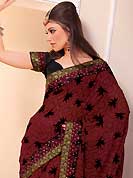 Embroidered sarees are the best choice for a girl to enhance her feminine look. This beautiful maroon chiffon saree is nicely designed with floral, geometric print, zari, stone and graceful patch border. Beautiful print work on saree make attractive to impress all. It will enhance your personality and gives you a singular look. Contrasting black blouse is available with this saree. Slight color variations are due to differing screen and photography resolution.