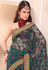 Try out this year top trend, glowing, bold and natural collection. This beautiful teal green tissue saree is nicely designed with velvet, gold print, zari, lace and graceful patch border. Beautiful print work on saree make attractive to impress all. It will enhance your personality and gives you a singular look. Contrasting maroon blouse is available with this saree. Slight color variations are due to differing screen and photography resolution.
