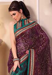 Ultimate collection of embroidered sarees with fabulous style. This beautiful dark purple and teal green tissue saree is nicely designed with velvet, gold print, zari, lace and graceful patch border. Beautiful print work on saree make attractive to impress all. It will enhance your personality and gives you a singular look. Matching teal green blouse is available with this saree. Slight color variations are due to differing screen and photography resolution.
