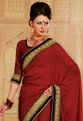 The evolution of style species collection spells pure femininity. This maroon raw silk saree is nicely designed with embroidery patch work is done with resham, zari, sequins, kundan, pearls and lace work. Saree gives you a singular and dissimilar look. Matching blouse is available. Slight color variations are possible due to differing screen and photograph resolution.