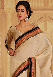 Ultimate collection of embroidery sarees with fabulous style. This beige raw silk saree is nicely designed with embroidery patch work is done with resham, zari, sequins, kundan, pearls and lace work. Saree gives you a singular and dissimilar look. Matching blouse is available. Slight color variations are possible due to differing screen and photograph resolution.