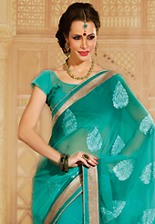 Envelope yourself in classic look with this charming saree. This shaded turquoise green chiffon saree is nicely designed with embroidery patch work is done with resham, stone and kundan work. Saree gives you a singular and dissimilar look. Matching blouse is available. Slight color variations are possible due to differing screen and photograph resolution.