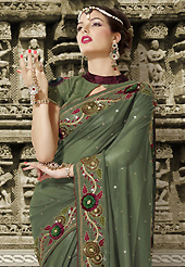 Take the fashion industry by storm in this beautiful embroidered saree. This shaded teal green net saree is nicely designed with embroidered patch work is done with resham and sequins work. Saree gives you a singular and dissimilar look. Matching blouse is available. Slight color variations are possible due to differing screen and photograph resolution.