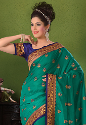 Keep the interest with this designer embroidery saree. This turquoise green dupion silk saree have beautiful embroidery and brocade patch bordered work which is embellished with resham, kasab, cutdana and stone work. Fabulous designed embroidery gives you an ethnic look and increasing your beauty. Contrasting dark blue blouse is available. Slight Color variations are possible due to differing screen and photograph resolutions.