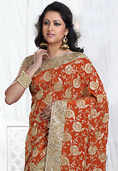 Envelope yourself in classic look with this charming saree. This rust crepe silk saree is nicely designed with embroidered patch work is done with resham, zari, stone and cutdana work. Saree gives you a singular and dissimilar look. Matching blouse is available. Slight color variations are possible due to differing screen and photograph resolution.