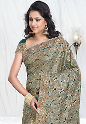 Elegance and innovation of designs crafted for you. This teal green crepe silk saree is nicely designed with embroidered patch work is done with resham, zari, sequins, stone, cutbeads and cutdana work. Saree gives you a singular and dissimilar look. Matching blouse is available. Slight color variations are possible due to differing screen and photograph resolution.