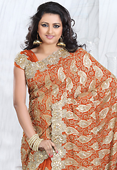 Get ready to sizzle all around you by sparkling saree. This rust crepe silk saree is nicely designed with embroidered patch work is done with zari, sequins, stone, cutdana and cutbeads work. Saree gives you a singular and dissimilar look. Matching blouse is available. Slight color variations are possible due to differing screen and photograph resolution.