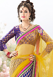 Keep the interest with this designer embroidery saree. This yellow and violet net and brocade lehenga style saree is nicely designed with embroidered patch work is done with resham, zari, stone and lace work. Beautiful embroidery patch border on saree make attractive to impress all. This saree gives you a modern and different look in fabulous style. Contrasting violet brocade blouse is available with this saree. Slight color variations are possible due to differing screen and photograph resolution.