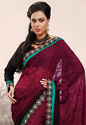 Envelope yourself in classic look with this charming saree. This burgundy brasso faux georgette saree is nicely designed with embroidered patch work is done with resham and zari work. Saree gives you a singular and dissimilar look. Matching blouse is available. Slight color variations are possible due to differing screen and photograph resolution.