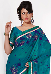 The traditional patterns used on this saree maintain the ethnic look. This teal georgette saree is nicely designed with embroidered patch work is done with resham, zari and lace work. Saree gives you a singular and dissimilar look. Matching blouse is available. Slight color variations are possible due to differing screen and photograph resolution.