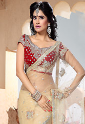 Style and trend will be at the peak of your beauty when you adorn this saree. This beige net saree is nicely designed with embroidered patch work is done with resham, stone, beads and cutbeads work. Saree gives you a singular and dissimilar look. Contrasting red blouse is available. Slight color variations are possible due to differing screen and photograph resolution.