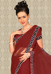 Get ready to sizzle all around you by sparkling saree. This maroon net saree is nicely designed with embroidered and velvet patch work is done with resham and stone work. This saree gives you a modern and different look in fabulous style. Matching blouse is available with this saree. Slight color variations are possible due to differing screen and photograph resolution.