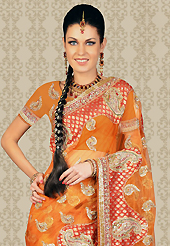 Dreamy variation on shape and forms compliment your style with tradition. This orange net saree is nicely designed with embroidery patch work is done with stone and beads work. This saree gives you a modern and different look in fabulous style. Matching blouse is available with this saree. Slight color variations are possible due to differing screen and photograph resolution.