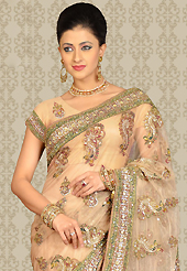 The traditional patterns used on this saree maintain the ethnic look. This light peach net saree is nicely designed with embroidery patch work is done with resham, sequins, stone and cutdana work. This saree gives you a modern and different look in fabulous style. Matching blouse is available with this saree. Slight color variations are possible due to differing screen and photograph resolution.