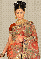 Ultimate collection of embroidery sarees with fabulous style. This rust tissue saree is nicely designed with embroidery patch work is done with resham, sequins, stone and cutdana work. This saree gives you a modern and different look in fabulous style. Matching blouse is available with this saree. Slight color variations are possible due to differing screen and photograph resolution.