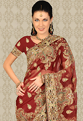 It is color this season and bright shaded suits are really something that is totally in vogue. This maroon tissue saree is nicely designed with embroidery patch work is done with resham, sequins, stone and cutdana work. This saree gives you a modern and different look in fabulous style. Matching blouse is available with this saree. Slight color variations are possible due to differing screen and photograph resolution.