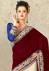 The most beautiful refinements for style and tradition. This maroon and off white velvet and net saree is nicely designed with embroidered patch work is done with resham, zari, stone, beads and lace work. Saree gives you a singular and dissimilar look. Contrasting blue blouse is available. Slight color variations are possible due to differing screen and photograph resolution.