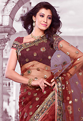 Exquisite combination of color, fabric can be seen here. This maroon net saree is nicely designed with embroidered patch work is done with resham, zari and sequins work. Saree gives you a singular and dissimilar look. Matching blouse is available. Slight color variations are possible due to differing screen and photograph resolution.