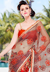 Welcome to the new era of Indian fashion wear. This light brown, green and red net and brosso saree is nicely designed with embroidered patch work is done with resham, zari, sequins and lace work. Beautiful embroidery work on saree make attractive to impress all. Matching blouse is available. Slight color variations are possible due to differing screen and photograph resolution.