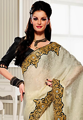 Dreamy variation on shape and forms compliment your style with tradition. This off white crepe jacquard saree have beautiful embroidery patch work which is embellished with resham, zari and stone work. Fabulous designed embroidery gives you an ethnic look and increasing your beauty. Contrasting black blouse is available. Slight Color variations are possible due to differing screen and photograph resolutions.