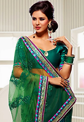 Welcome to the new era of Indian fashion wear. This green and bottle green net and crepe jacquard saree have beautiful embroidery patch work which is embellished with resham, zari, stone and lace work. Fabulous designed embroidery gives you an ethnic look and increasing your beauty. Matching blouse is available. Slight Color variations are possible due to differing screen and photograph resolutions.