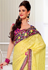 The most beautiful refinements for style and tradition. This yellow and deep pink jacquard and georgette saree have beautiful embroidery patch work which is embellished with resham, zari, stone and lace work. Fabulous designed embroidery gives you an ethnic look and increasing your beauty. Contrasting blue and pink blouse is available. Slight Color variations are possible due to differing screen and photograph resolutions.