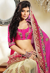 The most beautiful refinements for style and tradition. This pink and cream georgette and net lehenga style saree is nicely designed with embroidery patch work is done with resham, zari, stone, beads and lace work. Beautiful embroidery work on saree make attractive to impress all. This saree gives you a modern and different look in fabulous style. Matching blouse is available. Slight color variations are possible due to differing screen and photograph resolution.