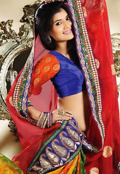 The traditional patterns used on this saree maintain the ethnic look. This red, orange and green chiffon and viscose saree is nicely designed with embroidery patch work is done with resham, zari and stone work. Beautiful embroidery work on saree make attractive to impress all. This saree gives you a modern and different look in fabulous style. Contrasting blue blouse is available. Slight color variations are possible due to differing screen and photograph resolution.