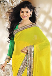 Try out this year top trend, glowing, bold and natural collection. This yellow georgette saree is nicely designed with embroidery patch work is done with zari, sequins, stone, beads and lace work. Beautiful embroidery work on saree make attractive to impress all. This saree gives you a modern and different look in fabulous style. Contrasting green blouse is available. Slight color variations are possible due to differing screen and photograph resolution.
