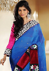 Ultimate collection of embroidery sarees with fabulous style. This blue georgette saree is nicely designed with embroidery patch work is done with resham, zari and stone work. Beautiful embroidery work on saree make attractive to impress all. This saree gives you a modern and different look in fabulous style. Contrasting pink blouse is available. Slight color variations are possible due to differing screen and photograph resolution.