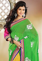 A desire that evokes a sense of belonging with a striking details. This green and yellow georgette saree is nicely designed with embroidery patch work is done with resham, zari and lace work. Beautiful embroidery work on saree make attractive to impress all. This saree gives you a modern and different look in fabulous style. Contrasting dark pink blouse is available. Slight color variations are possible due to differing screen and photograph resolution.