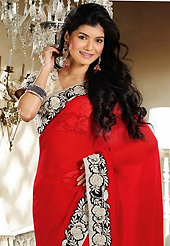 The glamorous silhouette to meet your most dire fashion needs. This red chiffon saree is nicely designed with embroidery patch work is done with resham and zari work. Beautiful embroidery work on saree make attractive to impress all. This saree gives you a modern and different look in fabulous style. Contrasting cream blouse is available. Slight color variations are possible due to differing screen and photograph resolution.