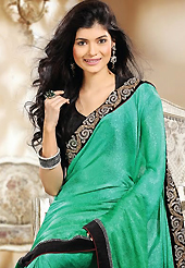 Your search for elegant look ends here with this lovely saree. This green georgette jacquard saree is nicely designed with embroidery patch work is done with zari and stone work. Beautiful embroidery work on saree make attractive to impress all. This saree gives you a modern and different look in fabulous style. Contrasting black blouse is available. Slight color variations are possible due to differing screen and photograph resolution.