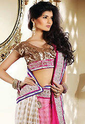 Let your personality articulate for you with this amazing embroidered saree. This pink and off white net and viscose saree is nicely designed with embroidery patch work is done with resham, zari and stone work. Beautiful embroidery work on saree make attractive to impress all. This saree gives you a modern and different look in fabulous style. Matching blouse is available. Slight color variations are possible due to differing screen and photograph resolution.