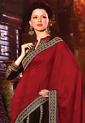 Ultimate collection of embroidery sarees with fabulous style. This dark red and black jacquard and faux georgette saree have beautiful embroidery patch work which is embellished with resham, zari, sequins and lace work. Fabulous designed embroidery gives you an ethnic look and increasing your beauty. Matching black blouse is available. Slight Color variations are possible due to differing screen and photograph resolutions.