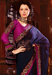 Take a look on the changing fashion of the season. This navy blue net lehenga style saree have beautiful embroidery patch work which is embellished with resham, zari, sequins and stone work. Fabulous designed embroidery gives you an ethnic look and increasing your beauty. Contrasting magenta blouse is available. Slight Color variations are possible due to differing screen and photograph resolutions.