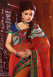 The traditional patterns used on this saree maintain the ethnic look. This red and orange faux georgette saree have beautiful embroidery patch work which is embellished with resham, zari, sequins, stone and lace work. Fabulous designed embroidery gives you an ethnic look and increasing your beauty. Contrasting dark blue blouse is available. Slight Color variations are possible due to differing screen and photograph resolutions.