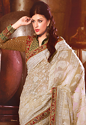 Your search for elegant look ends here with this lovely saree. This cream faux georgette saree have beautiful embroidery patch work which is embellished with resham and zari work. Fabulous designed embroidery gives you an ethnic look and increasing your beauty. Contrasting mustard blouse is available. Slight Color variations are possible due to differing screen and photograph resolutions.