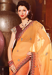 A desire that evokes a sense of belonging with a striking details. This shaded orange faux georgette saree have beautiful embroidery patch work which is embellished with resham, zari and stone work. Fabulous designed embroidery gives you an ethnic look and increasing your beauty. Contrasting dark brown blouse is available. Slight Color variations are possible due to differing screen and photograph resolutions.