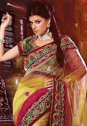 Exquisite combination of color, fabric can be seen here. This off white, yellow and dark pink net saree have beautiful embroidery patch work which is embellished with resham, zari, stone and beaded lace work. Fabulous designed embroidery gives you an ethnic look and increasing your beauty. Contrasting green blouse is available. Slight Color variations are possible due to differing screen and photograph resolutions.