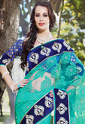 Ultimate collection of embroidery sarees with fabulous style. This sea green net brasso saree have beautiful embroidery patch work which is embellished with zari, stone and beads work. Fabulous designed embroidery gives you an ethnic look and increasing your beauty. Contrasting blue brocade blouse is available. Slight Color variations are possible due to differing screen and photograph resolutions.